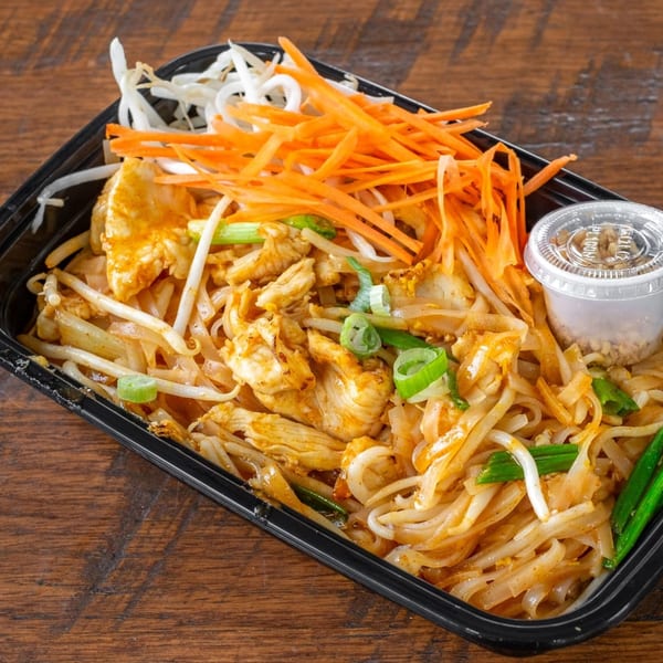 Easy Thai Bend's chicken Pad Thai with bean sprouts, shredded carrots, and green onions.