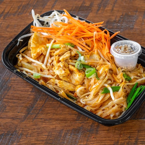 Easy Thai Bend's Pad Thai with chicken, bean sprouts, shredded carrots, and a side of crushed peanuts.